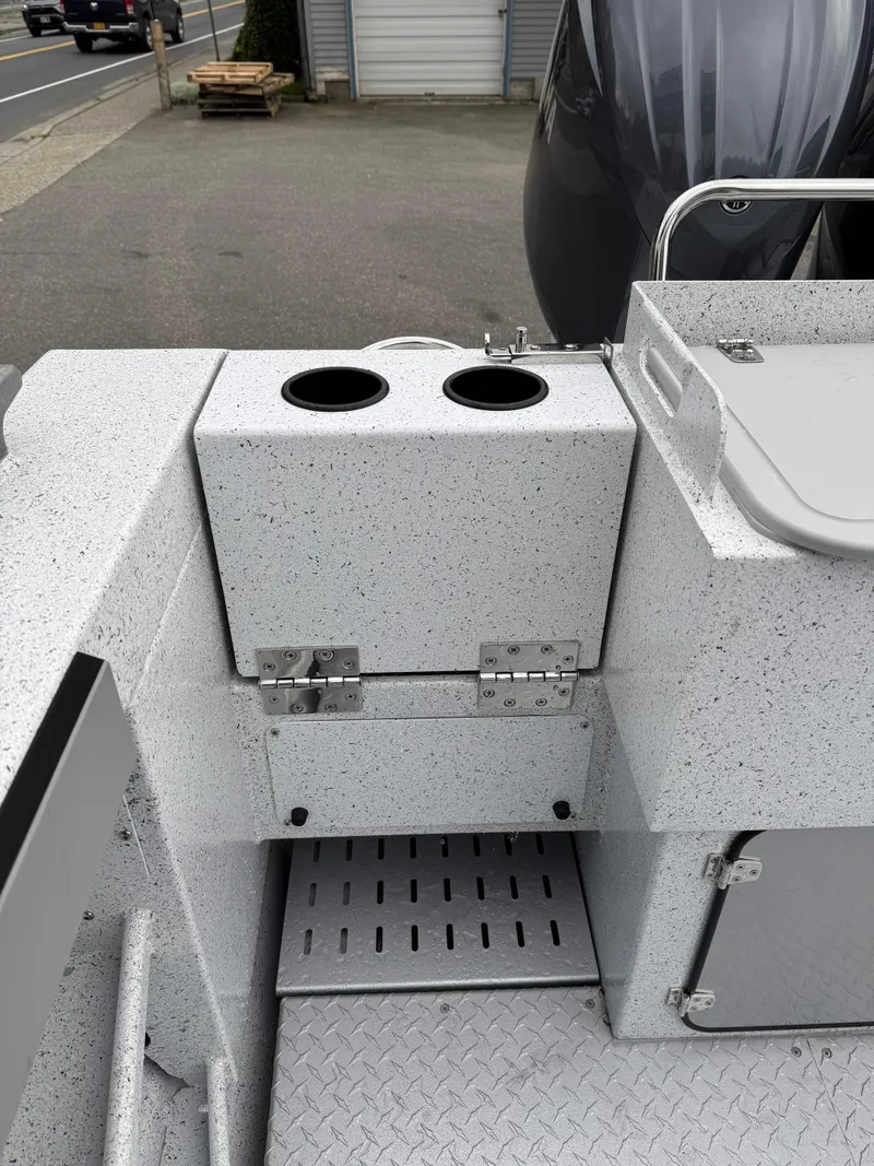 Slide: The Image of 2025 KingFisher 2825 Coastal Express boat deck with cup holders and storage compartments. - 14