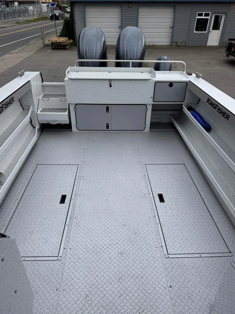Slide: The Image of 2025 KingFisher 2825 Coastal Express boat interior with storage compartments and twin engines. - 15