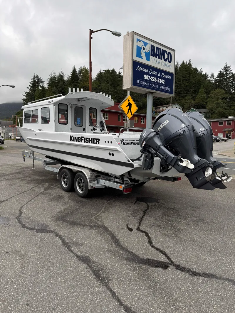Slide: The Image of 2025 KingFisher 2825 Coastal Express boat on trailer in parking lot. - 2