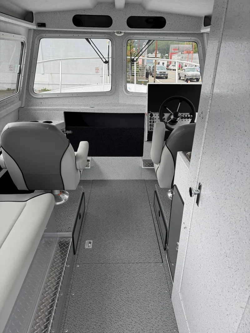 Slide: The Image of Interior of 2025 KingFisher 2825 Coastal Express boat, featuring modern seating and steering area. - 4