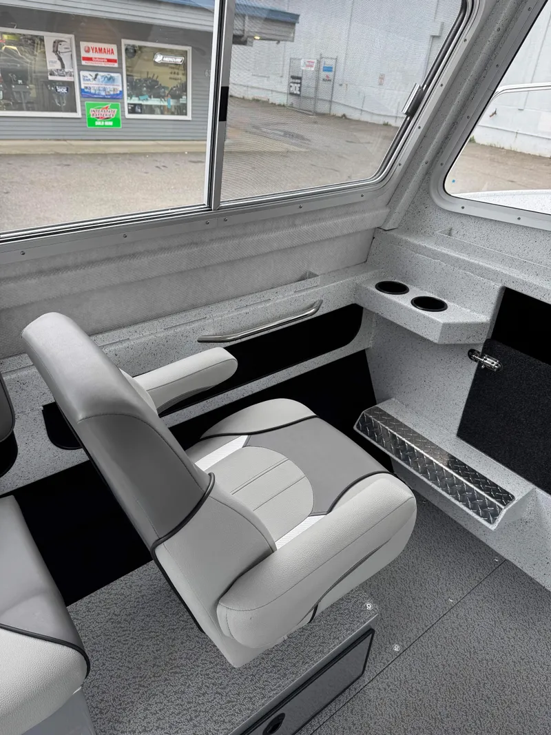 Slide: The Image of 2025 KingFisher 2825 Coastal Express interior with gray seating and cup holders. - 6