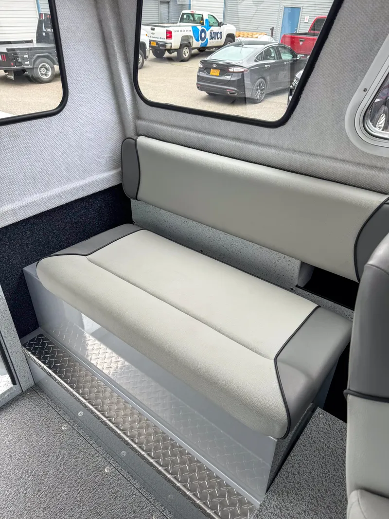 Slide: The Image of Interior seating of 2025 KingFisher 2825 Coastal Express boat, featuring gray upholstery. - 7
