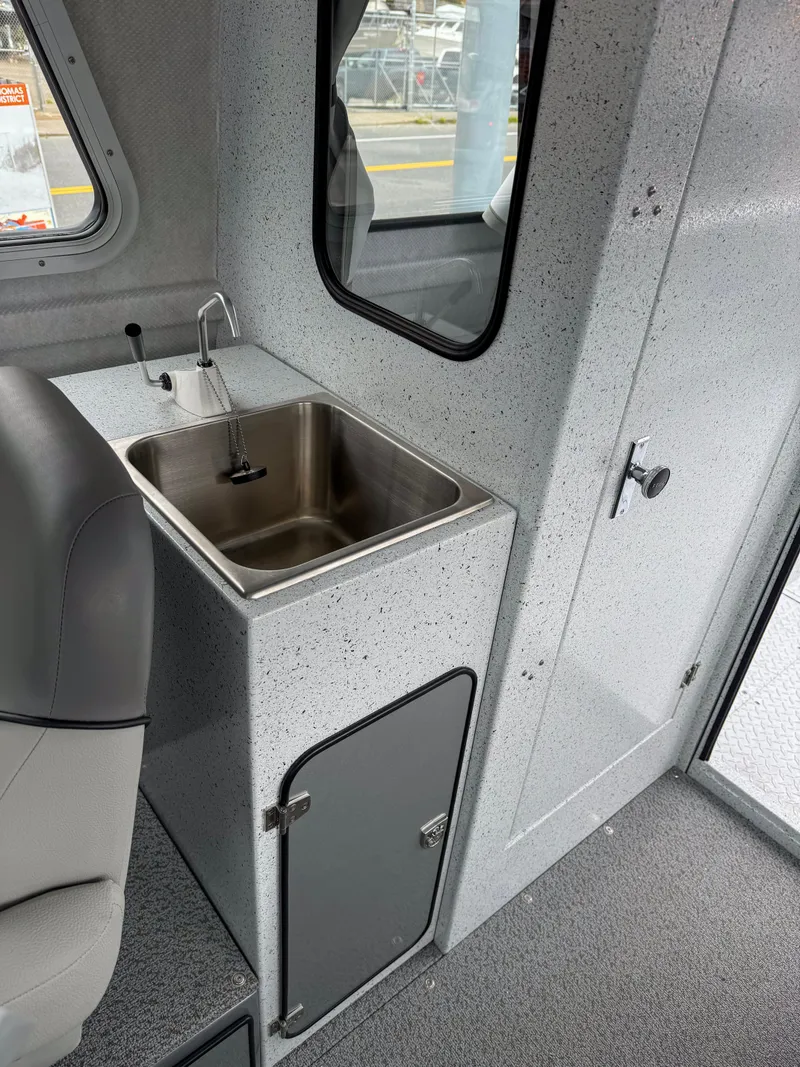 Slide: The Image of 2025 KingFisher 2825 Coastal Express interior with sink and storage cabinet. - 8