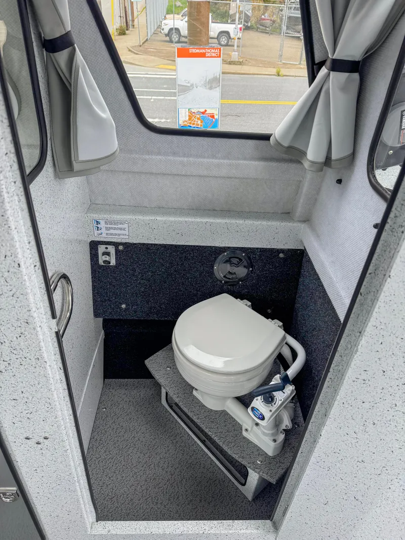 Slide: The Image of 2025 KingFisher 2825 Coastal Express boat interior with compact marine toilet. - 9