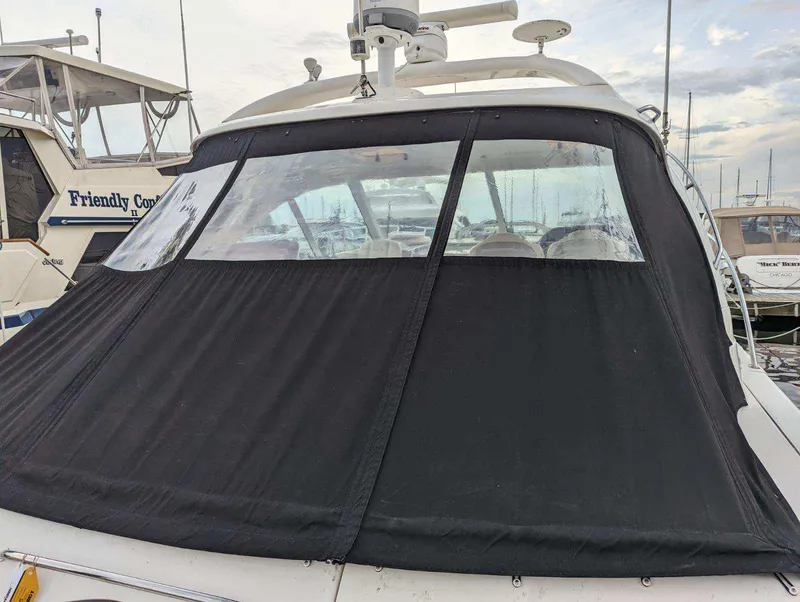 Slide: The Image of 2008 Sea Ray 48 Sundancer with black canvas cover in marina. - 10