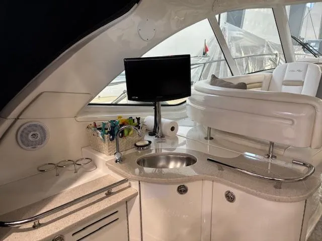 Slide: The Image of Interior of 2009 Sea Ray 48 Sundancer yacht with kitchenette and TV. - 16