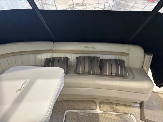 Slide: The Image of 2009 Sea Ray 48 Sundancer interior with beige seating and striped cushions. - 18