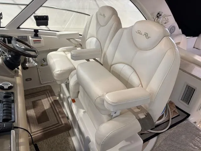 Slide: The Image of 2009 Sea Ray 48 Sundancer helm with luxurious white leather seats. - 20