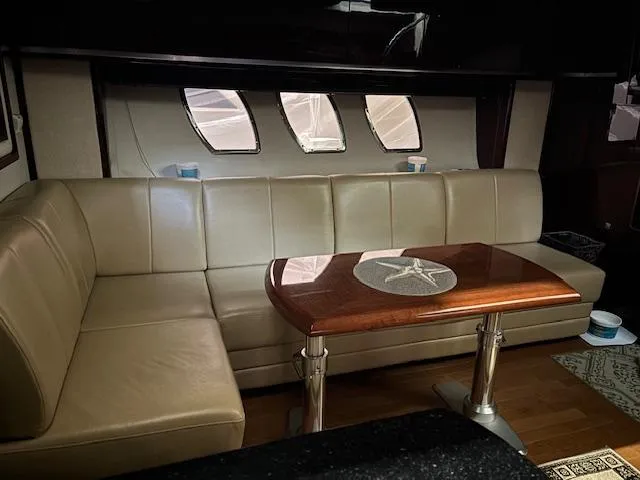 Slide: The Image of Luxurious interior of 2009 Sea Ray 48 Sundancer yacht with leather seating and wooden table. - 23