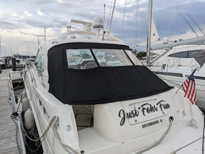 Slide: The Image of 2008 Sea Ray 48 Sundancer yacht docked, featuring "Just For Fun" name and American flag. - 8