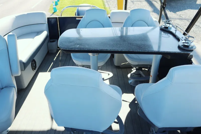 Slide: The Image of Sweetwater 2186 MT 2021 boat interior with seating and table. - 14