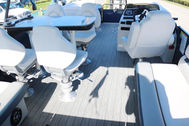Slide: The Image of 2021 Sweetwater 2186 MT boat interior with white seating and steering console. - 16