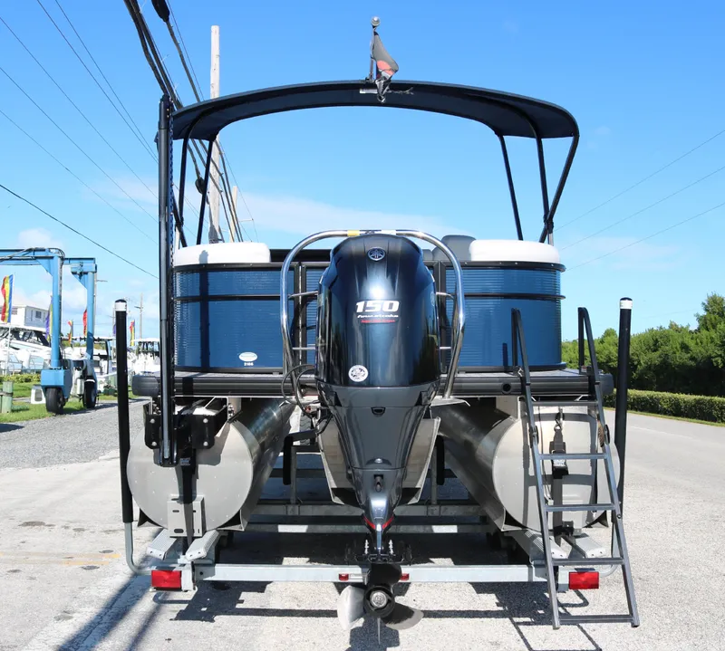 Slide: The Image of 2021 Sweetwater 2186 MT pontoon boat with 150 HP engine, parked on trailer. - 4