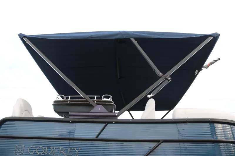 Slide: The Image of Sweetwater 2186 MT 2021 boat with blue canopy and sleek design. - 5