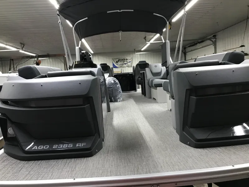 Slide: The Image of 2025 Avalon GEOfish REAR FISH boat interior with seating and canopy in a showroom. - 11