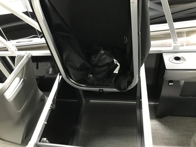 Slide: The Image of Interior view of 2025 Avalon GEOfish REAR FISH boat, showcasing storage compartment and seating. - 26