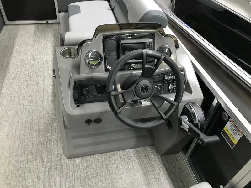 Slide: The Image of Steering console of 2025 Avalon GEOfish REAR FISH boat with modern controls and seating. - 28