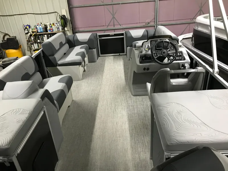 Slide: The Image of Interior of 2025 Avalon GEOfish REAR FISH boat with modern seating and steering console. - 29
