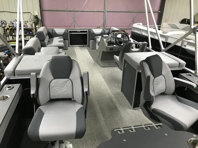 Slide: The Image of Interior of 2025 Avalon GEOfish REAR FISH boat with modern seating and steering console. - 30