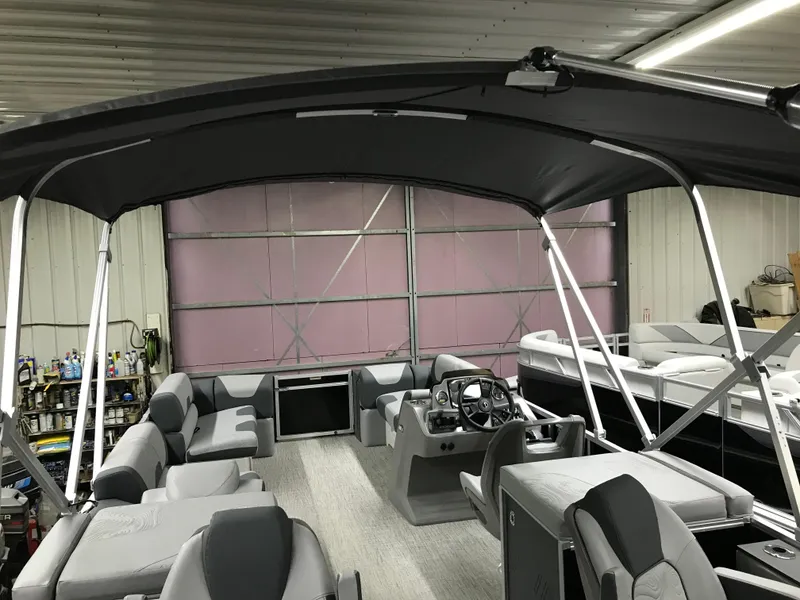 Slide: The Image of 2025 Avalon GEOfish REAR FISH boat interior with seating and canopy in a garage. - 31