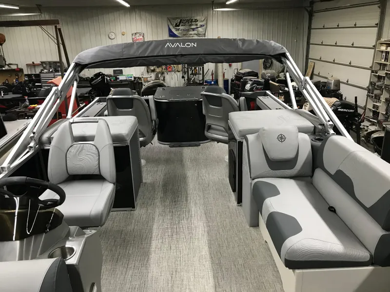 Slide: The Image of 2025 Avalon GEOfish REAR FISH boat interior with gray seating and canopy. - 35