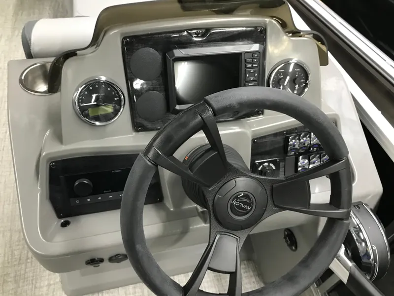 Slide: The Image of Steering console of 2025 Avalon GEOfish REAR FISH boat with modern controls and display. - 38