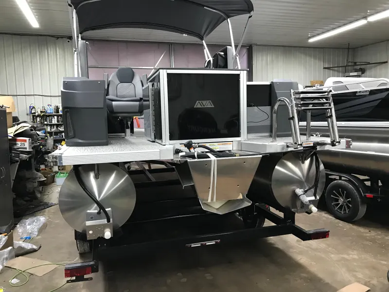 Slide: The Image of 2025 Avalon GEOfish REAR FISH boat in a garage, showcasing rear design and seating. - 4