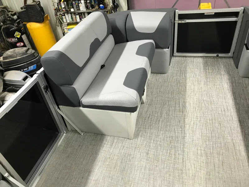 Slide: The Image of 2025 Avalon GEOfish REAR FISH boat interior with gray seating and carpeted floor. - 40