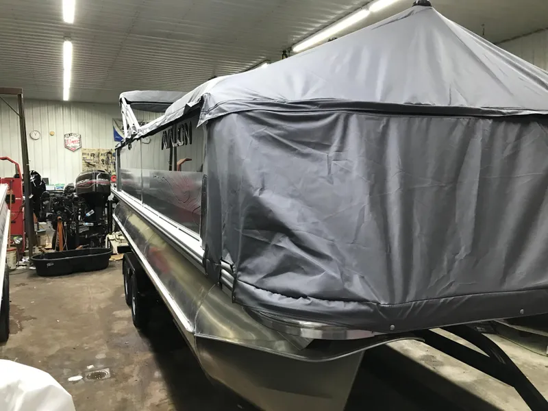 Slide: The Image of 2025 Avalon GEOfish REAR FISH boat covered in a garage setting. - 45