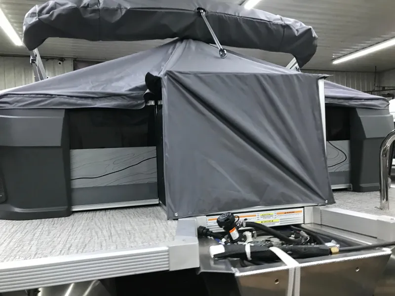 Slide: The Image of 2025 Avalon GEOfish REAR FISH boat with covered rear section in a showroom. - 48