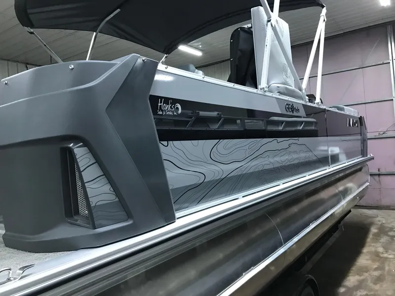 Slide: The Image of Avalon GEOfish REAR FISH 2025 boat with sleek design and modern features in a showroom. - 7