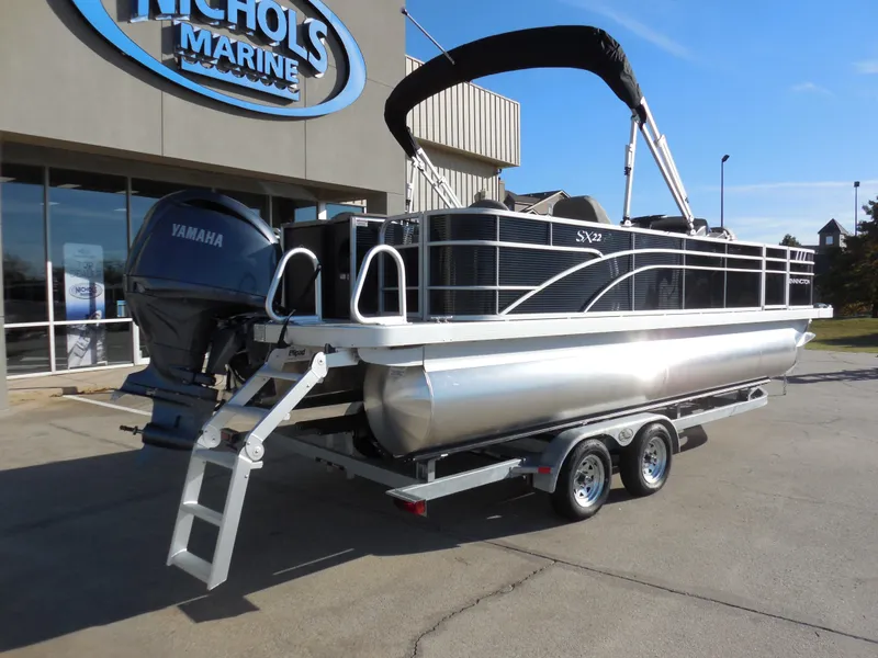 Slide: The Image of 2025 Bennington 22 SFX APG pontoon boat on trailer outside Nichols Marine. - 3