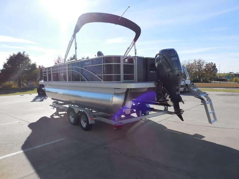 Slide: The Image of 2025 Bennington 22 SFX APG pontoon boat on trailer in sunny parking lot. - 4
