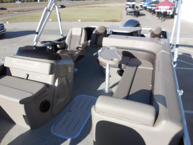 Slide: The Image of 2025 Bennington 22 SFX APG pontoon boat interior with beige seating and helm. - 7