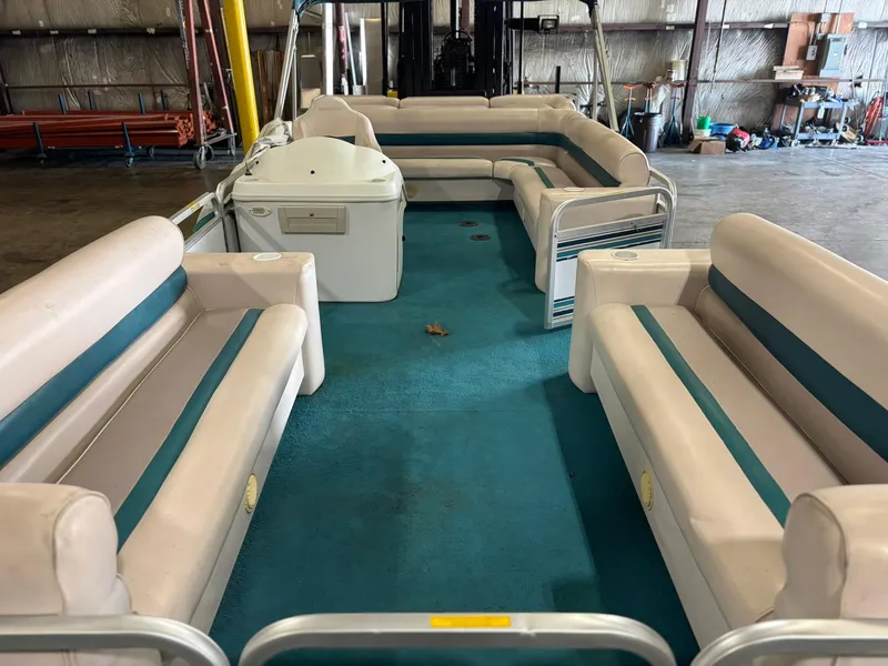 Slide: The Image of 1998 Godfrey AquaPatio 240 LE pontoon boat interior with teal and beige seating. - 2