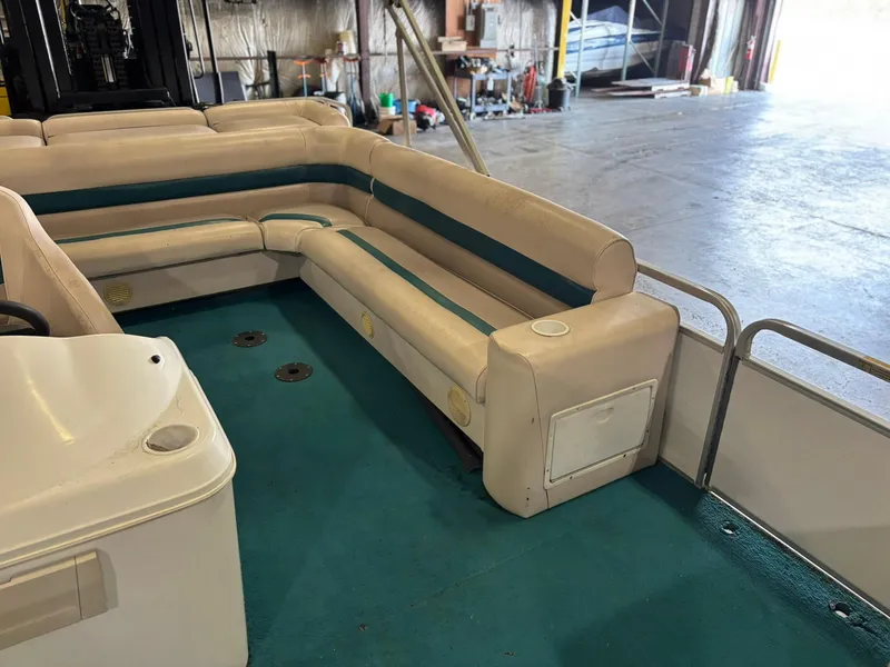 Slide: The Image of Interior of a 1998 Godfrey AquaPatio 240 LE pontoon boat with teal and cream seating. - 3