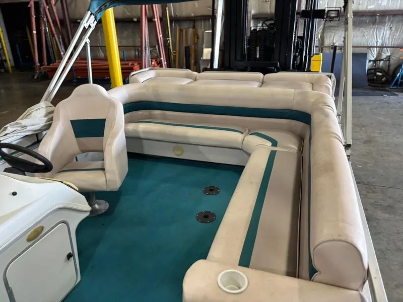 Slide: The Image of Interior of a 1998 Godfrey AquaPatio 240 LE pontoon boat with beige seating. - 4