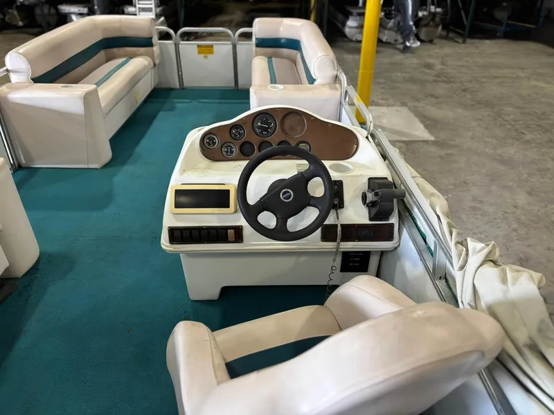 Slide: The Image of 1998 Godfrey AquaPatio 240 LE boat interior with steering wheel and seating. - 5