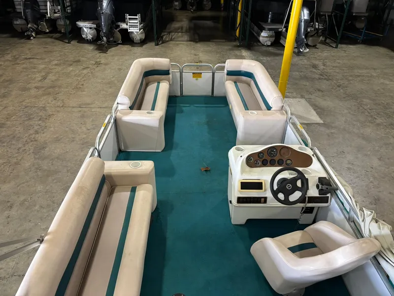 Slide: The Image of 1998 Godfrey AquaPatio 240 LE pontoon boat with spacious seating and steering console. - 6