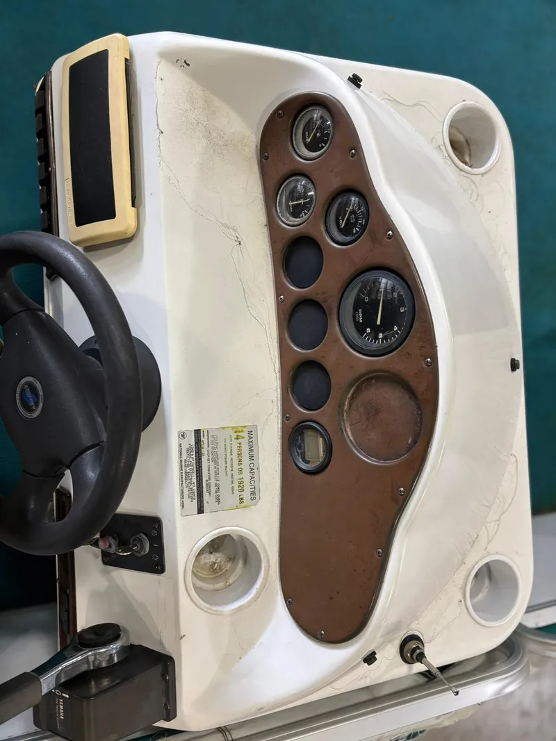 Slide: The Image of 1998 Godfrey AquaPatio 240 LE boat dashboard with steering wheel and gauges. - 8