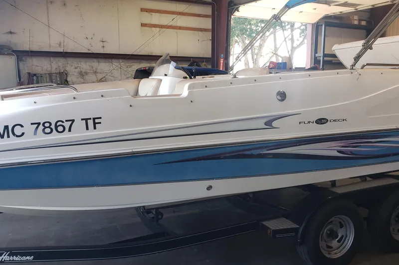 Slide: The Image of 2009 Hurricane FunDeck GS 202 I/O boat in storage, side view with trailer. - 10