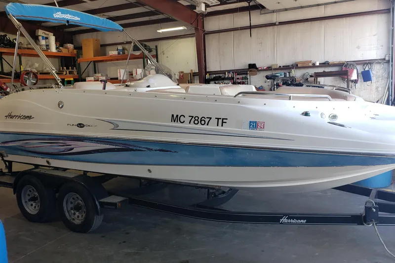 Slide: The Image of 2009 Hurricane FunDeck GS 202 I/O boat on trailer in a garage setting. - 2