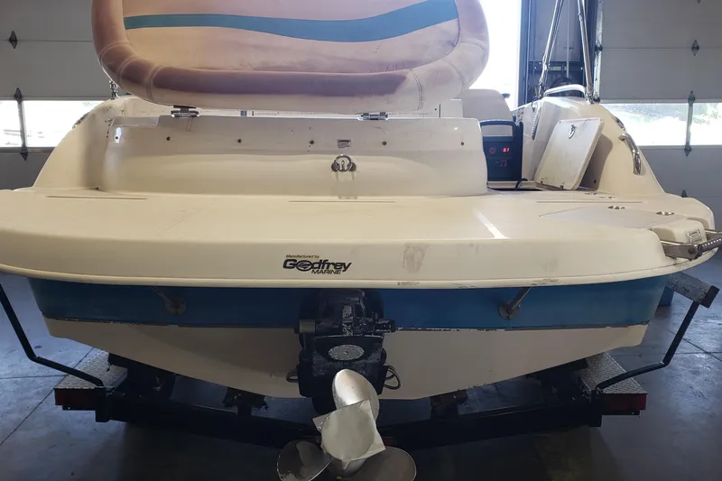 Slide: The Image of 2009 Hurricane FunDeck GS 202 I/O boat in garage, rear view with outboard motor. - 7