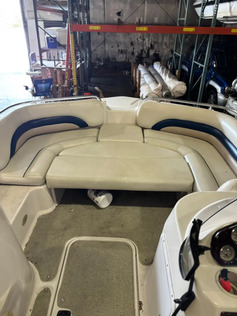 Slide: The Image of 2001 Hurricane FunDeck GS 201 I/O boat interior with seating in a warehouse setting. - 1