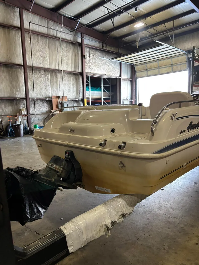 Slide: The Image of 2001 Hurricane FunDeck GS 201 I/O boat in a warehouse setting. - 10