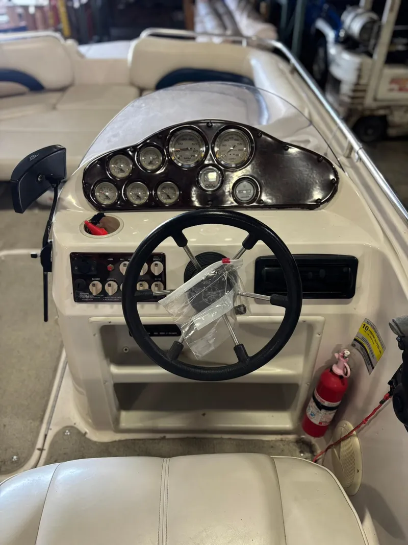 Slide: The Image of 2001 Hurricane FunDeck GS 201 I/O boat dashboard with steering wheel and gauges. - 5