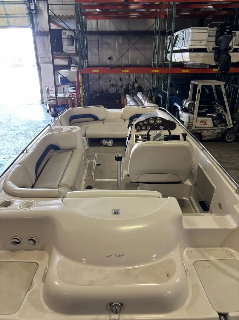 Slide: The Image of 2001 Hurricane FunDeck GS 201 I/O boat in storage, interior view with seating and steering. - 7