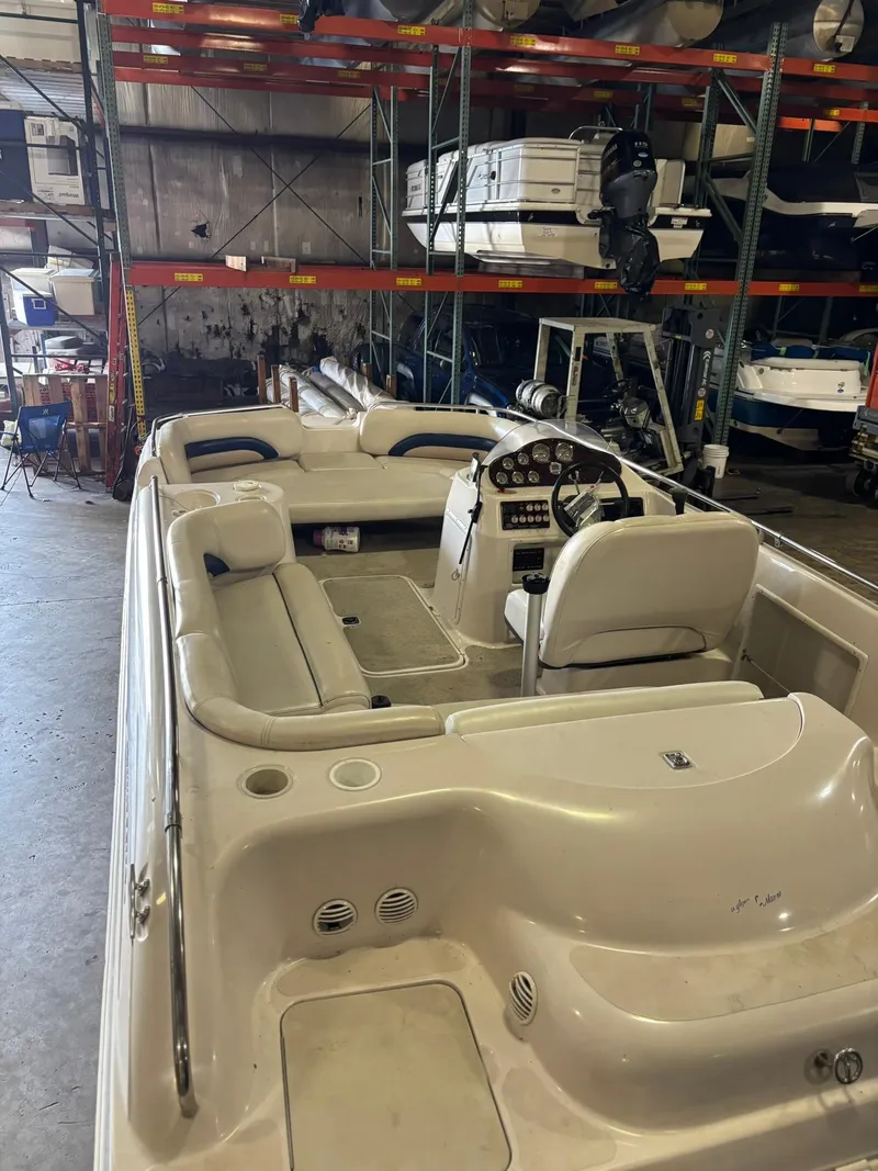 Slide: The Image of 2001 Hurricane FunDeck GS 201 I/O boat in indoor storage, showcasing seating and helm. - 8