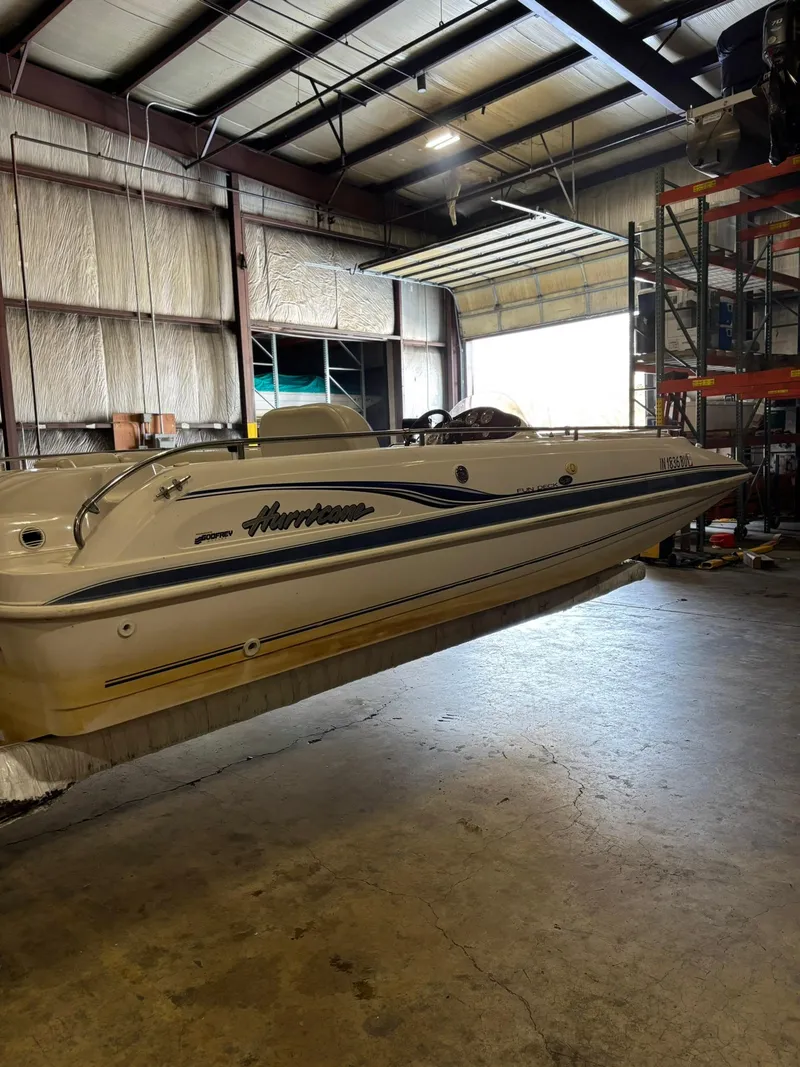 Slide: The Image of 2001 Hurricane FunDeck GS 201 I/O boat in a warehouse setting. - 9