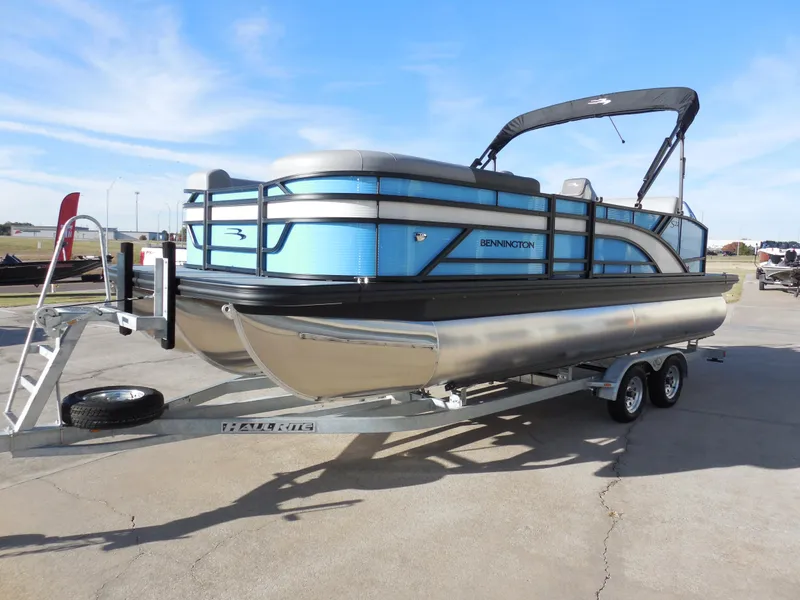 Slide: The Image of 2025 Bennington 22 SSB pontoon boat on trailer, blue and silver design. - 5